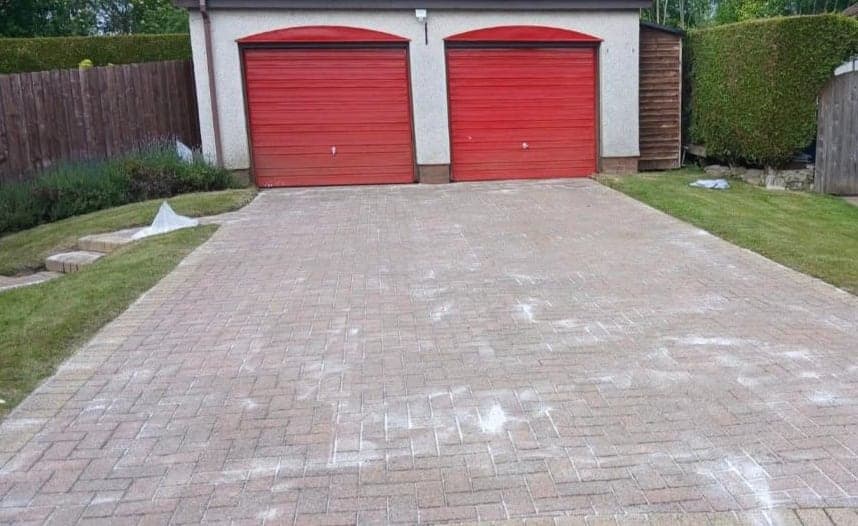 Double driveway, red garage doors, cleaned by Steam King